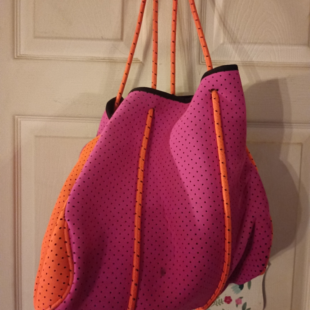 Large beach bag in pink and orange. Has a wallet to match.